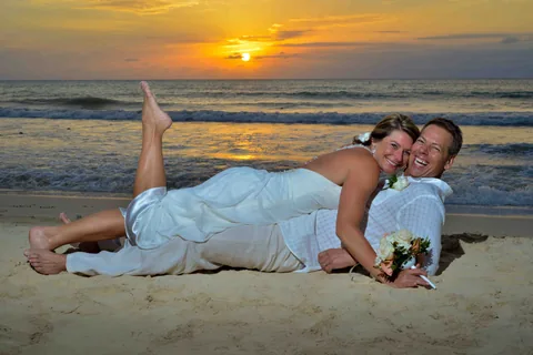 Newlywed couple on Seven Mile Beach at sunset